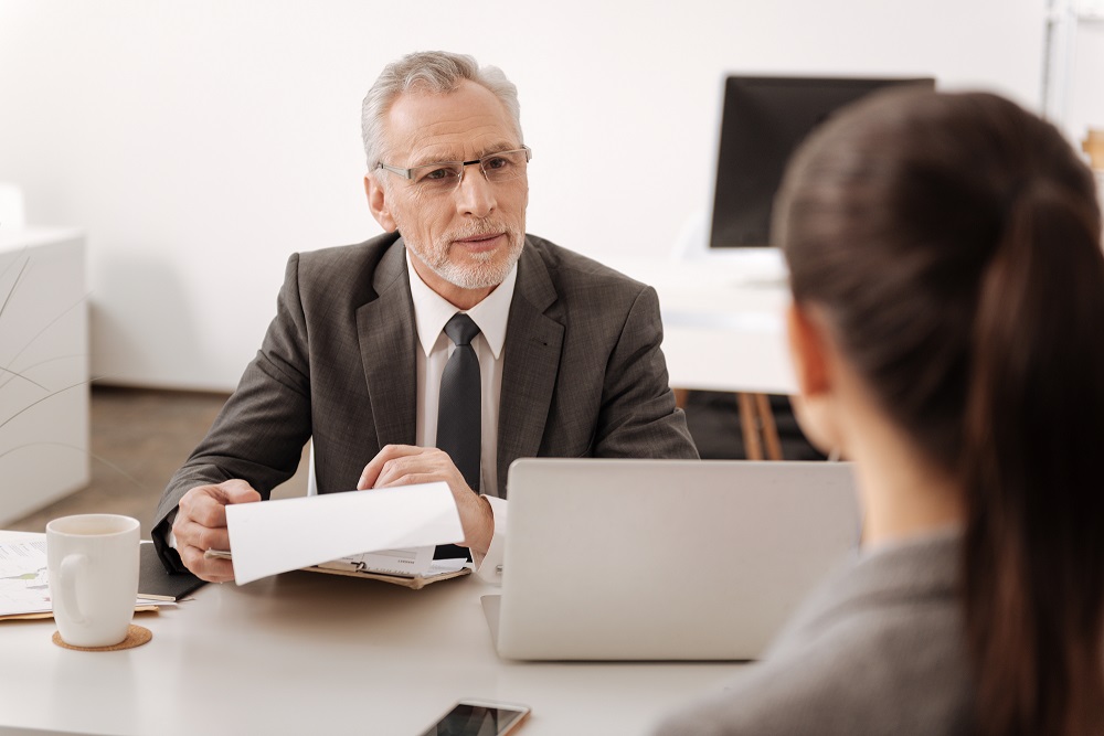 Boss and Employee Speaking in Room